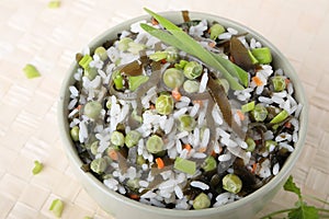 Bowl of salad with rice, laminaria and green peas
