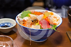 Bowl of sashimi, Japanese raw seafood, including shrimp, tuna, c