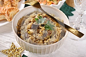 A bowl of sauerkraut with mushrooms and prunes for Christmas Eve supper