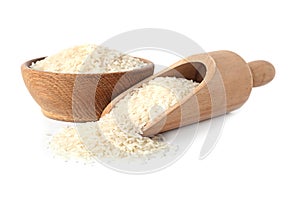 Bowl and scoop with uncooked long grain rice on white