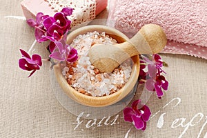 Bowl of sea salt and orchid flowers