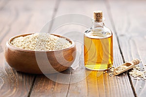 Bowl of sesame seeds and oil bottle