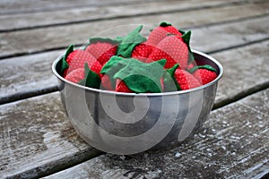 A bowl of sewn strawberries on wood