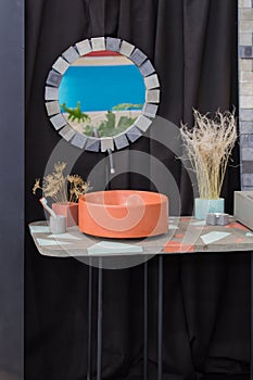 Bowl-shaped concrete sink, orange cement sink, black faucet, wall mirror, original bathroom