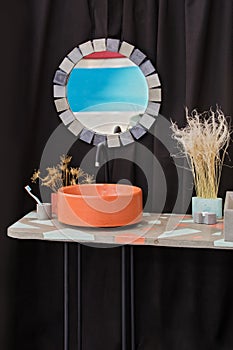 Bowl-shaped concrete sink, orange cement sink, black faucet, wall mirror, original bathroom