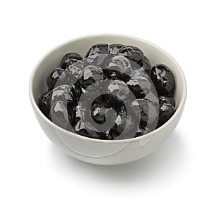 Bowl with shiny black olives