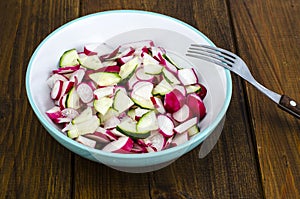 Bowl with sliced fresh radish and cucumber, vegetarian food