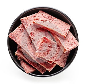 Bowl of sliced ham isolated on white; from above