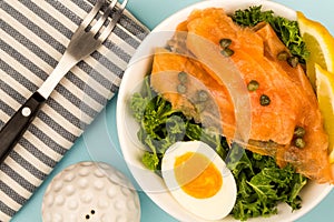 Bowl Of Smoked Salmon With Capers And Kale With A Boiled Egg And