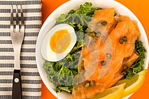 Bowl Of Smoked Salmon With Capers And Kale With A Boiled Egg And