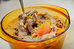 A bowl of Soto Betawi, Indonesian native traditional soup made of beef or beef offal cooked in coconut milk broth