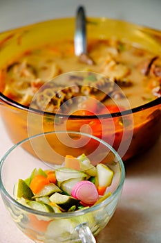 A bowl of Soto Betawi, Indonesian native traditional soup made of beef or beef offal cooked in coconut milk broth with pickles