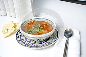 Bowl of Soup With Spoon and Two Salt Shakers