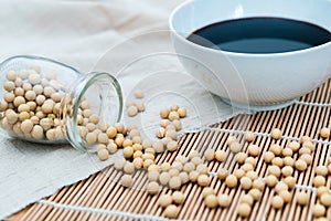 A bowl of soy sauce and sprinkled soybeans photo
