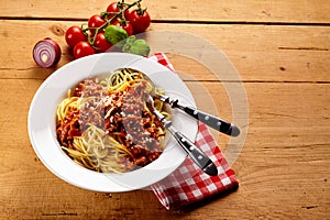 Bowl of spaghetti bolognese with tomatoes on vine