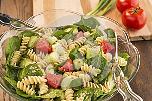 Bowl of spinach and rotini pasta salad photo