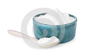 Bowl and spoon with sweet fructose powder on white background