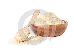 Bowl and spoon with uncooked parboiled rice isolated on white