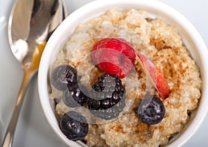 Bowl of steel cut oats served with fresh fruit and