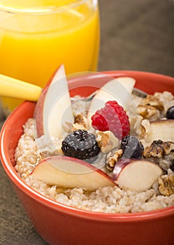 Bowl of steel cut oats served with fresh fruit and honey