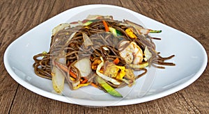 Bowl of stir fried udon noodles with mixed seafood and eggs. Asian traditional food: Yaki Soba Tori