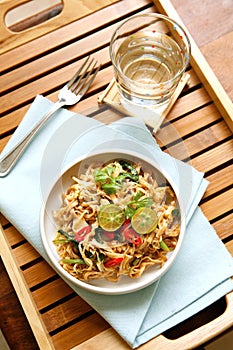 Bowl of stirfry noodle with fresh limes photo