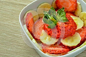 Bowl with strawberries and banana slices