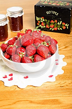 Bowl of strawberries and jars of jam