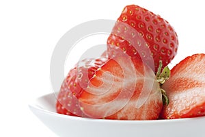 Bowl with strawberries, one halved