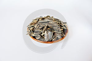 Bowl of Sunflower seeds isolated on white background.