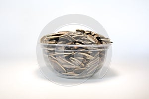 Bowl of Sunflower seeds isolated on white background.