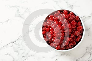 Bowl of sweet cherries on marble background