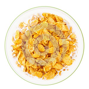 Bowl of sweet cornflakes with milk isolated on white background, top view