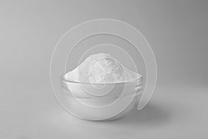 Bowl of sweet fructose powder isolated on white