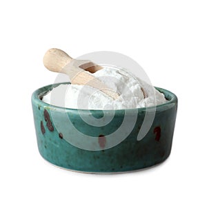 Bowl with sweet fructose powder and scoop on white