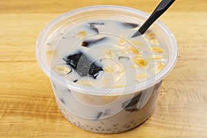 bowl syrup mixed with grass jelly and mangoes and peanuts and tapiocas and guiling jelly etc. at horizontal composition