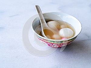 Bowl of tangyuan / tang yuan, a traditional Chinese desert of glutinous rice flour balls in a sweet soup eaten on the Dongzhi and