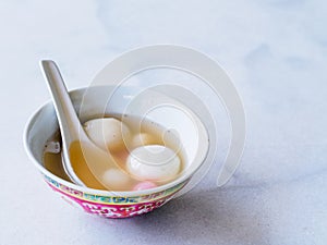 Bowl of tangyuan / tang yuan, a traditional Chinese desert of glutinous rice flour balls in a sweet soup eaten on the Dongzhi and photo