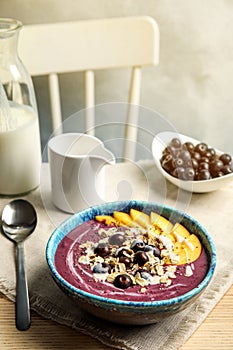 Bowl with tasty acai smoothie