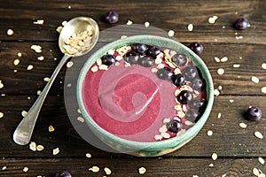 Bowl with tasty acai smoothie on table