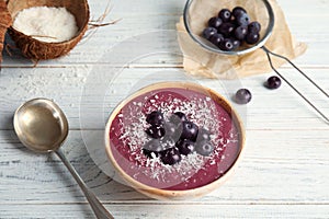 Bowl with tasty acai smoothie on table