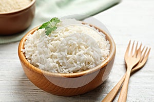 Bowl of tasty cooked rice on table photo