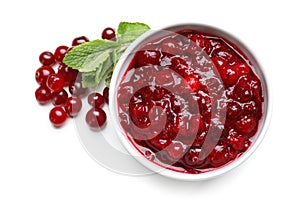 Bowl with tasty cranberry sauce on white background, top view