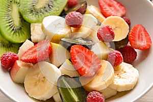 Bowl with tasty fruit salad, closeup