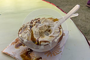 A bowl of tasty healthy homemade vanilla ice cream with chocolate sauce