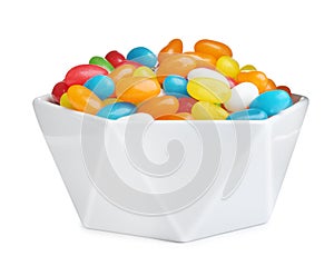 Bowl of tasty jelly beans on background