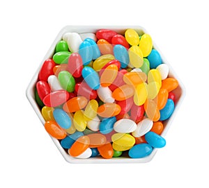 Bowl of tasty jelly beans on white background