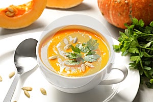 Bowl with tasty pumpkin soup served