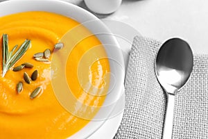 Bowl with tasty pumpkin soup served