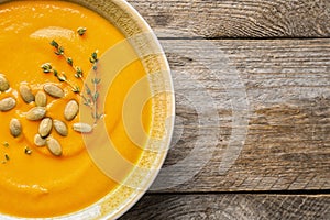 Bowl with tasty pumpkin soup and space for text